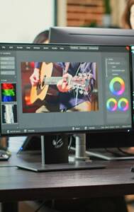 African american employee editing video content on multimedia software